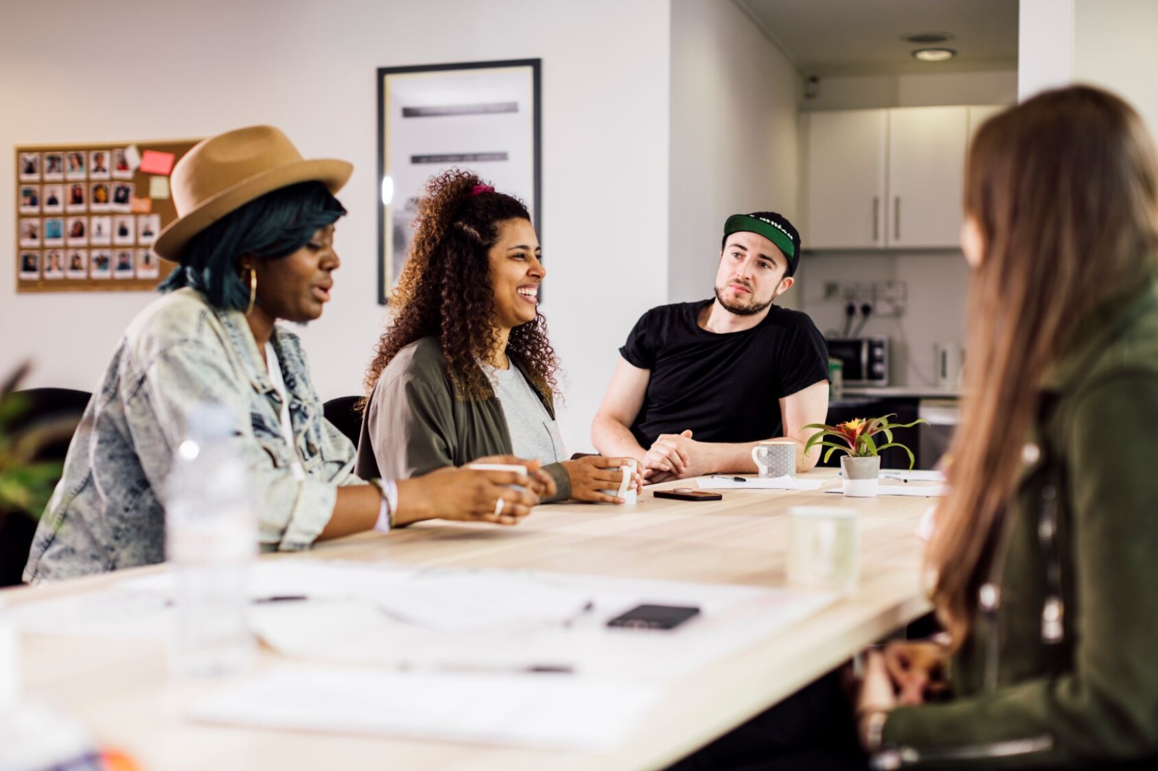 3 people sit round a table