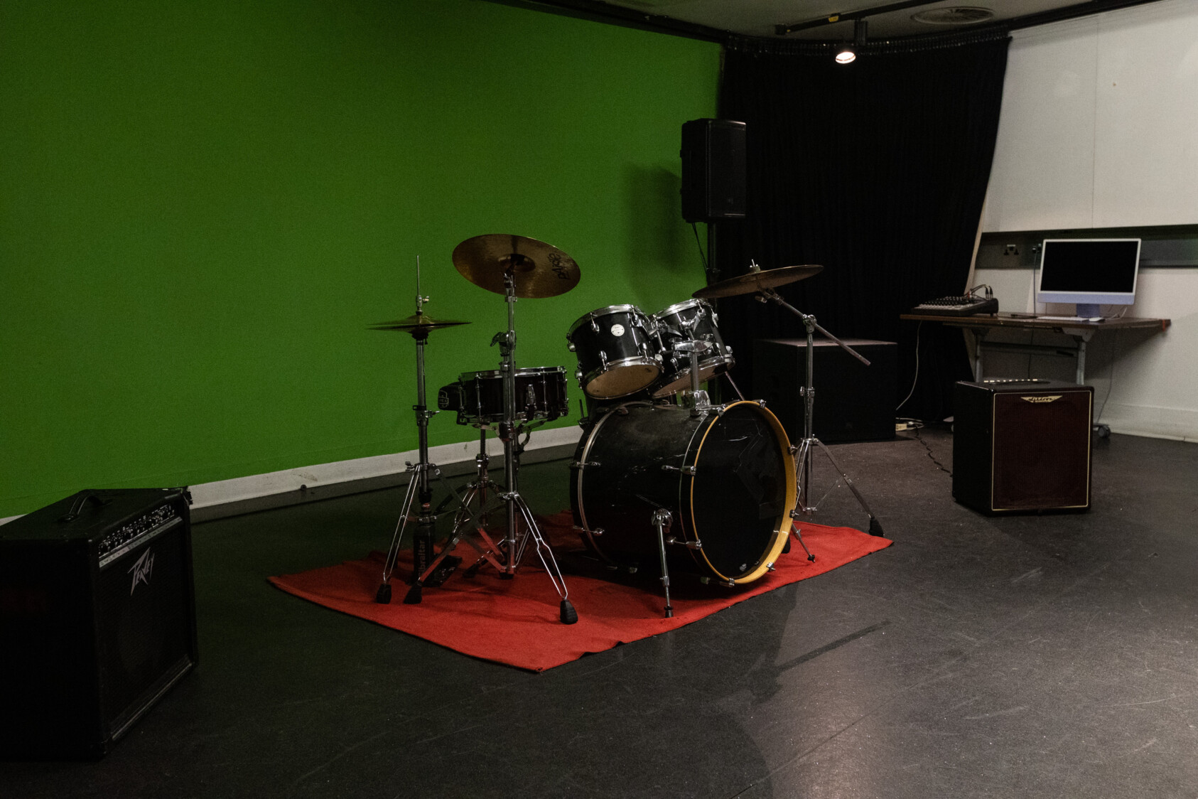 A drum kit against a green background