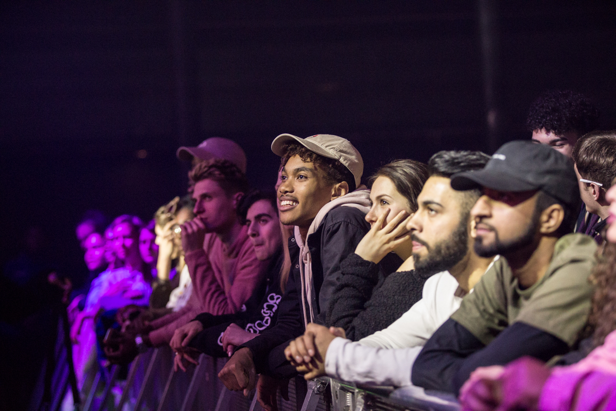 The front row of a crowd smiling