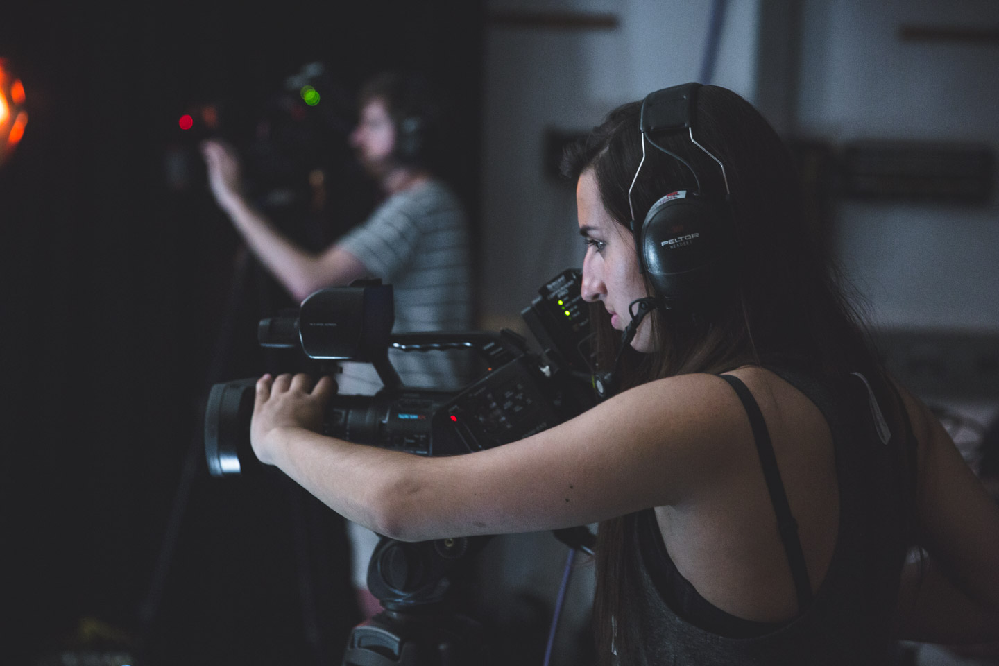 Image of a camera operator in foreground and second camera operator in background