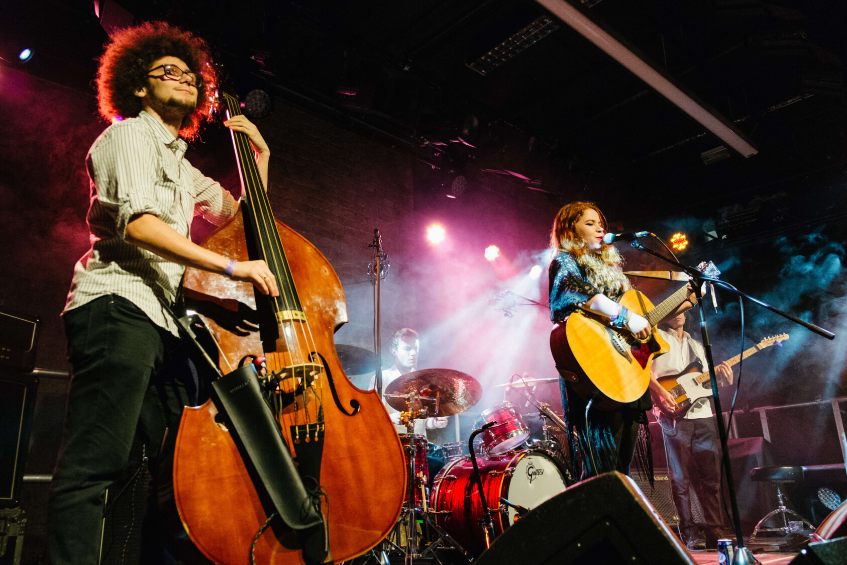 One person playing the double bass and another playing the guitar