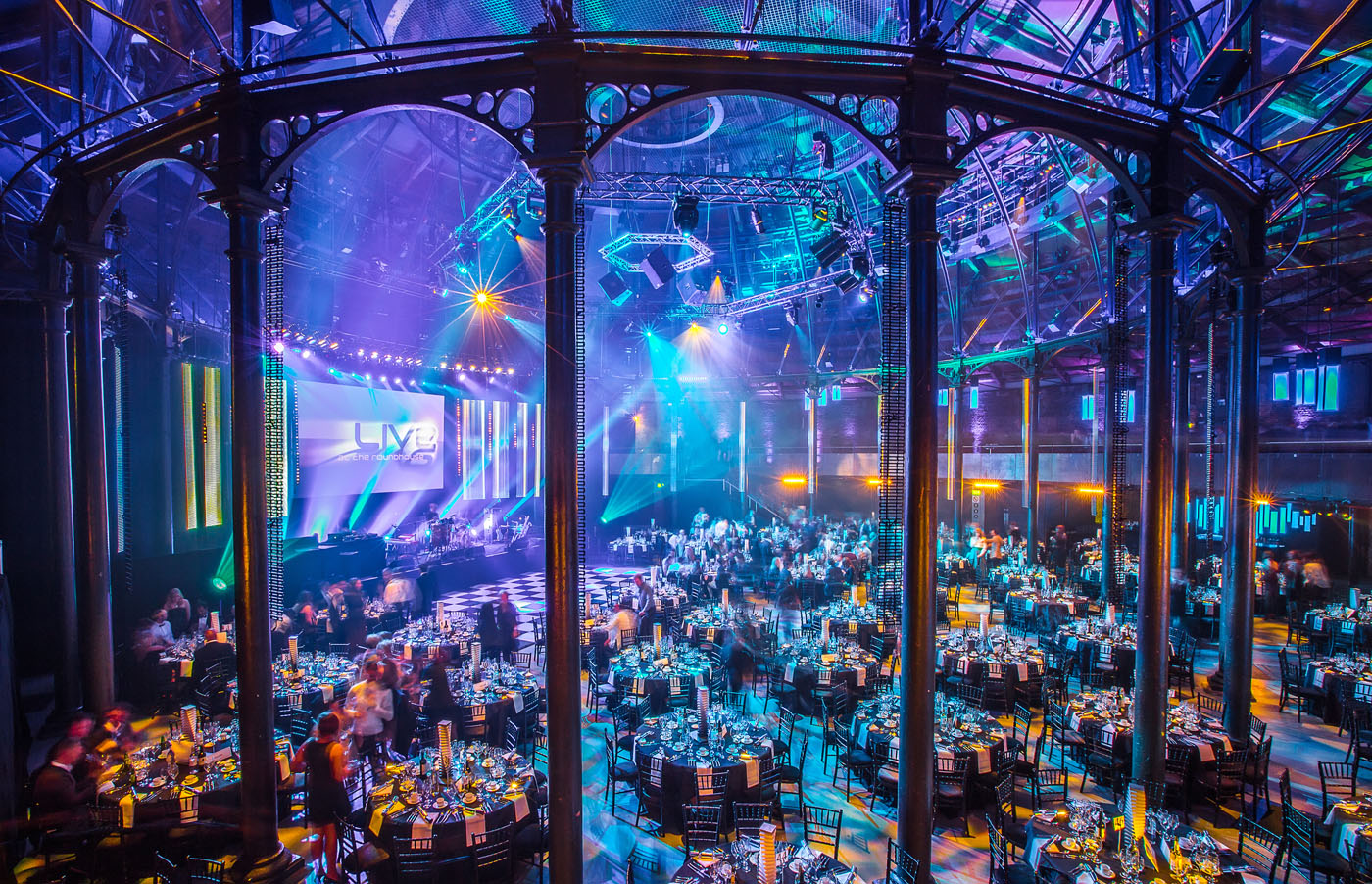 Roundhouse Main Space set up with round tables for an awards ceremony dinner