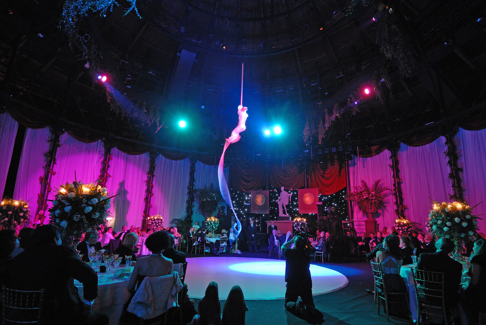 Aerial artist performing in the Main Space with event attendees watching while seated