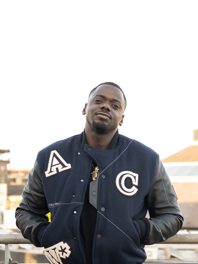 Daniel Kaluuya standing on a balcony opposite the Roundhouse