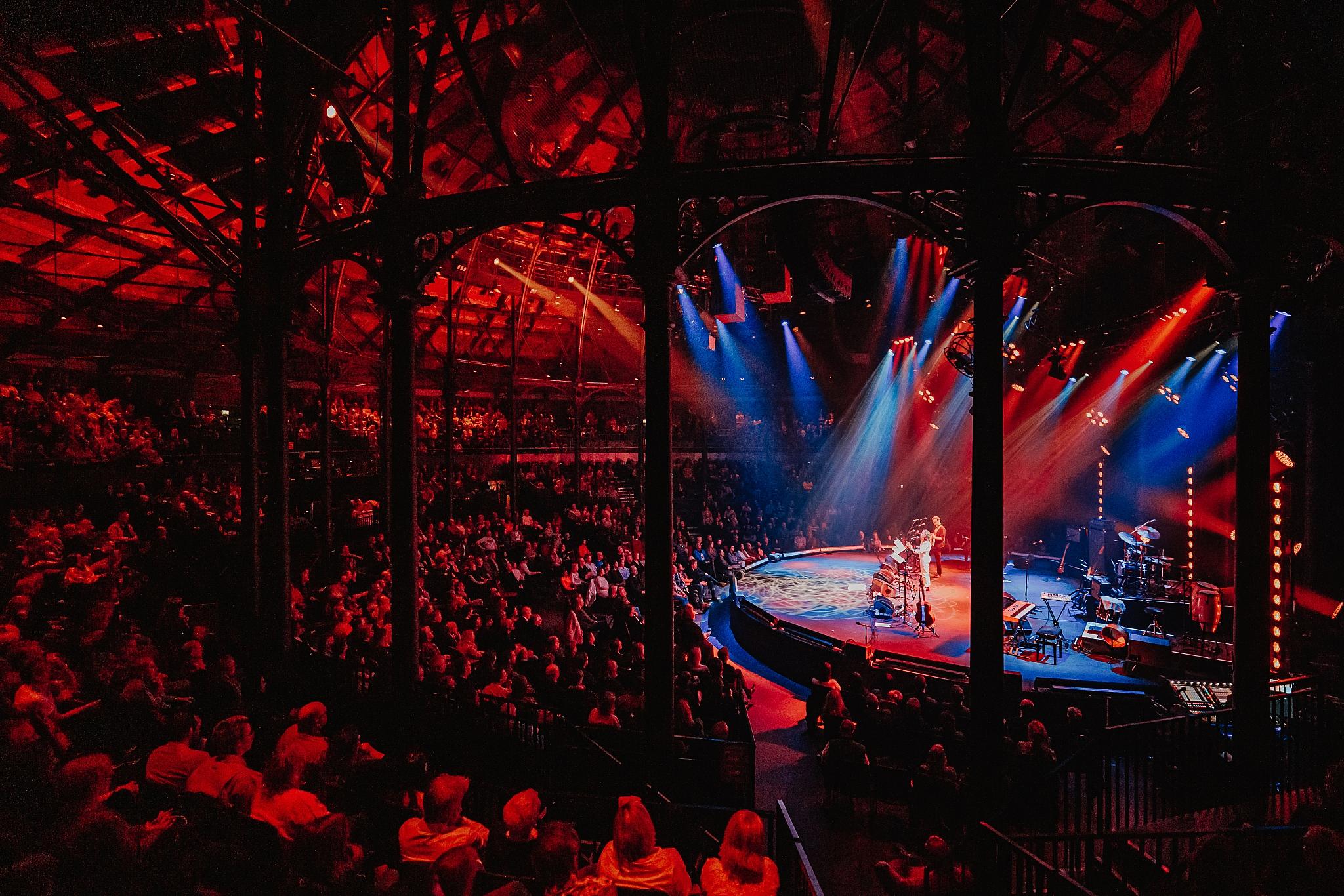 Roundhouse main space lit up in red and blue