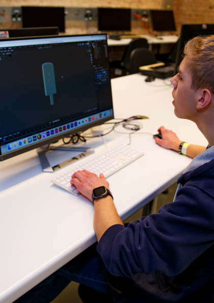 young person sitting at a computer learning animation