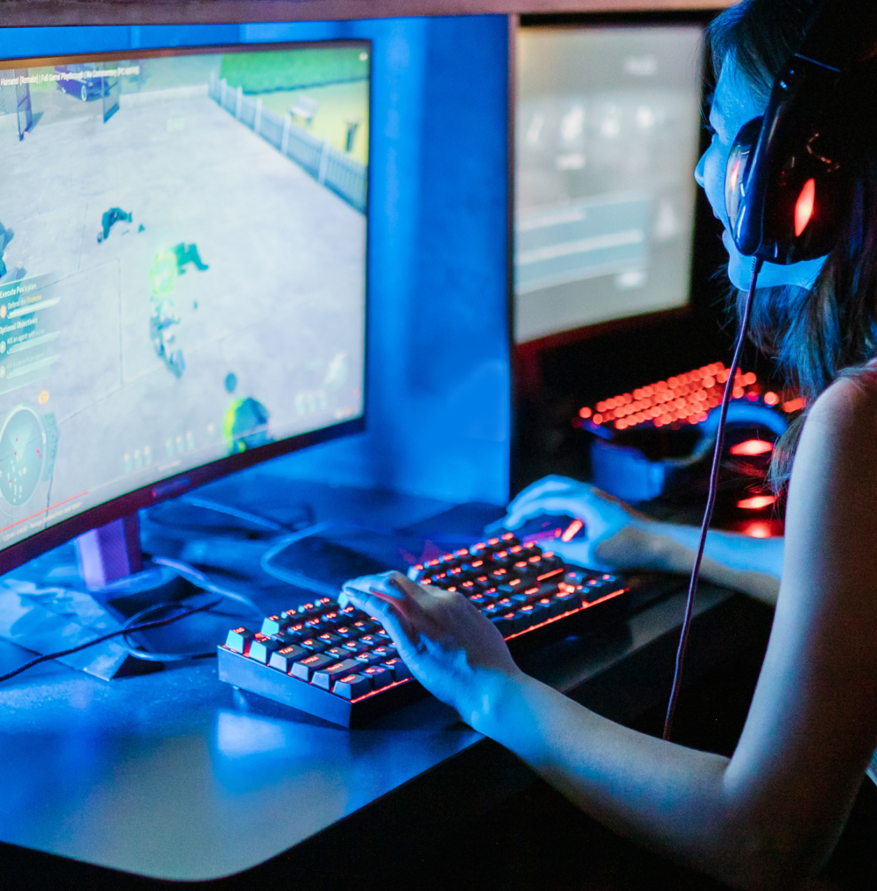 A young person sat at a computer using game design software