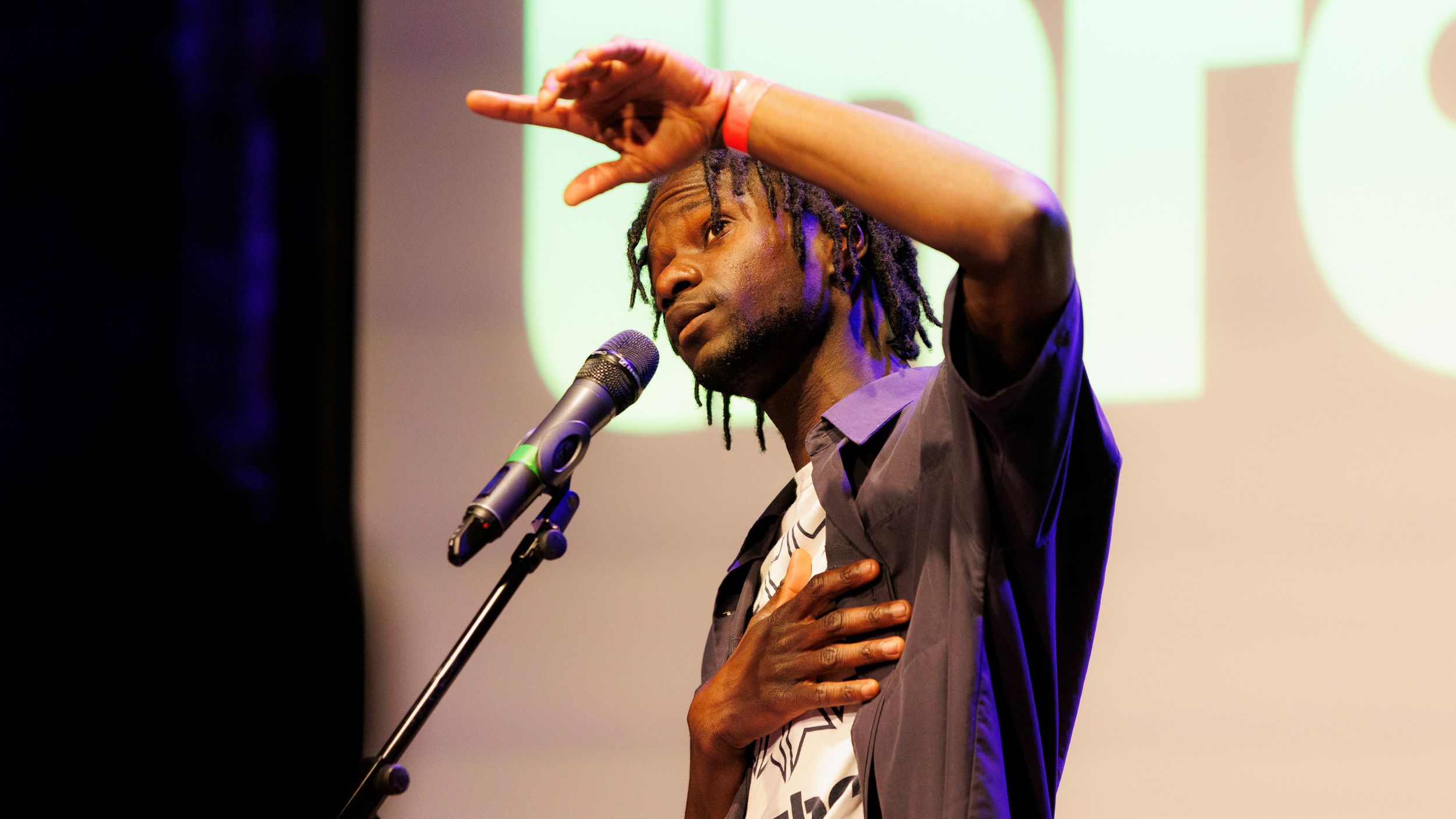 A man performing at a microphone