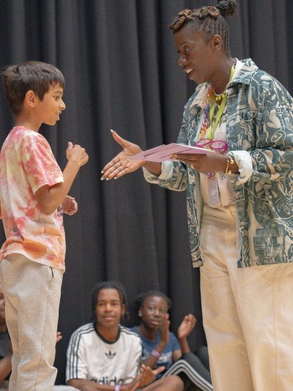 adult facilitator shaking hands with a young person