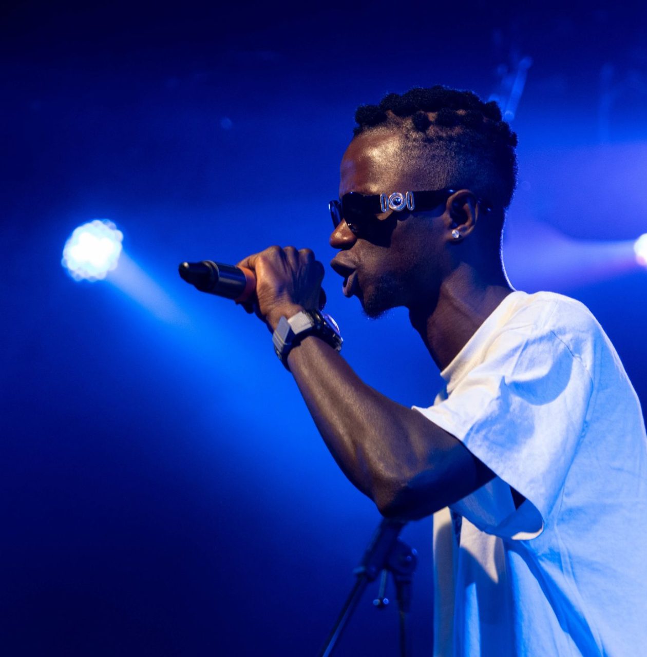 a teenager onstage performing into a mic