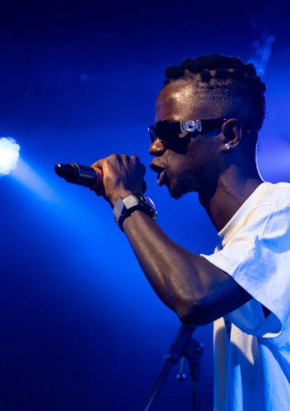 a teenager onstage performing into a mic