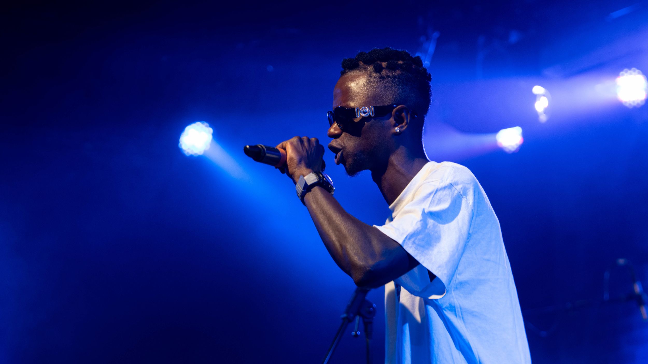 a teenager onstage performing into a mic